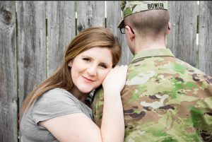 Army wife leaning on soldier's shoulder