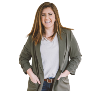Military spouse, Michelle Bowler, smiling in an olive blazer, white shirt and jeans.